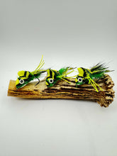 Load image into Gallery viewer, Three green and yellow artificial frog flies on a piece of wood 